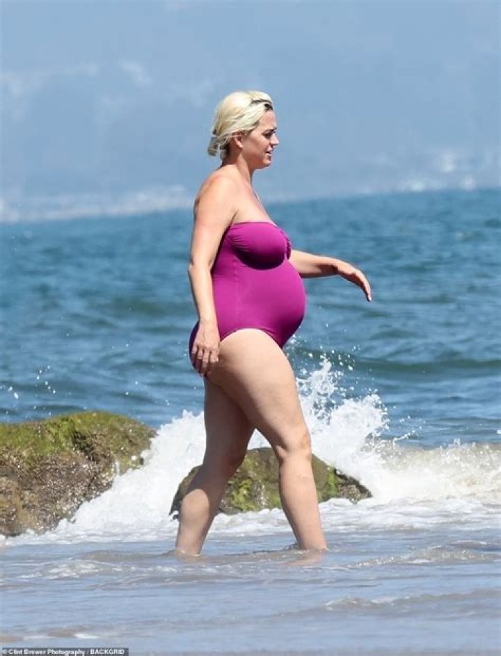 Pregnant Katy Perry Rubs Baby Bump In Purple One-Piece On Beach Date With Orlando Bloom