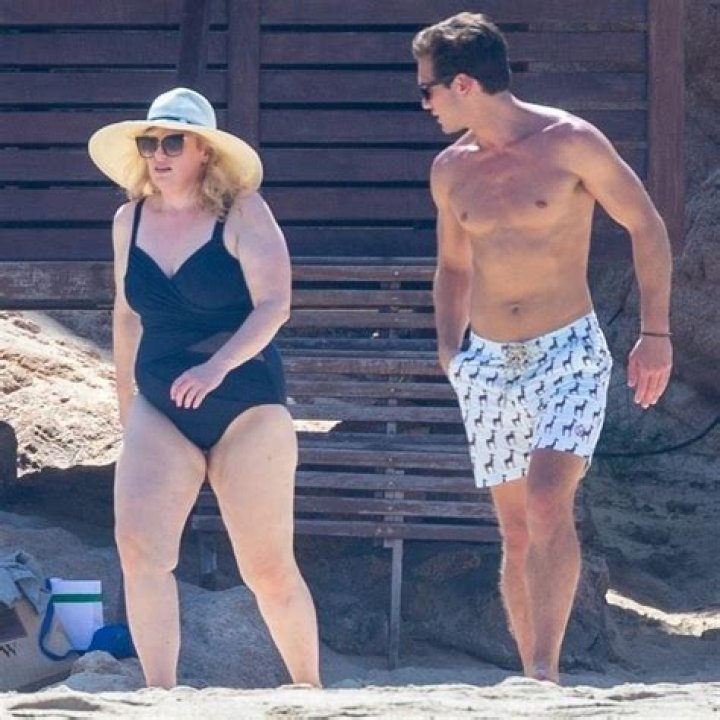 Rebel Wilson Sunbathes In A Low-Cut Swimsuit & Her Ex Jacob Busch Is Here For It